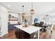 An open-concept kitchen showcasing an island with seating, a bar area, and seamless access to the living space at 14453 Glapthorn Rd, Fishers, IN 46037