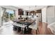 Stylish kitchen with modern dark cabinetry, stainless steel appliances, and dining area at 14453 Glapthorn Rd, Fishers, IN 46037