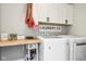 Efficient laundry room with white cabinets, wooden countertop and modern washer and dryer at 14453 Glapthorn Rd, Fishers, IN 46037