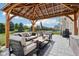 Inviting outdoor patio with pergola, comfortable seating, and stylish coffee table, perfect for relaxation and entertaining at 14453 Glapthorn Rd, Fishers, IN 46037