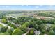 Wide aerial view of a community with nearby school, sport fields, and a bus parking area at 1482 Waterford Dr, Zionsville, IN 46077
