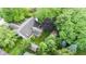 An aerial view of a backyard showcasing mature trees and beautiful landscaping at 1482 Waterford Dr, Zionsville, IN 46077