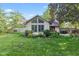 Well-maintained backyard with lush lawn, mature landscaping, and view of the home's rear exterior at 1482 Waterford Dr, Zionsville, IN 46077