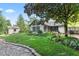 Expansive backyard featuring manicured lawn, gardens, and a view of the house and storage shed at 1482 Waterford Dr, Zionsville, IN 46077