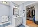 Bathroom with a white vanity, neutral walls, and a view into the walk-in closet at 1482 Waterford Dr, Zionsville, IN 46077