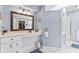 Well-lit bathroom with a vanity, large mirror, and accessibility features at 1482 Waterford Dr, Zionsville, IN 46077