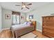 Comfortable bedroom with wood floors, ceiling fan, and natural light from the window at 1482 Waterford Dr, Zionsville, IN 46077