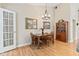 Dining room with wood table and chairs and French doors to living room at 1482 Waterford Dr, Zionsville, IN 46077