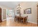Dining room with wood table and chairs and French doors to a sitting area at 1482 Waterford Dr, Zionsville, IN 46077