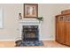 Close up of the fireplace with white mantle and a black screen, set on a black marble at 1482 Waterford Dr, Zionsville, IN 46077