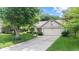 Home exterior with manicured lawn, driveway and a large tree in the yard at 1482 Waterford Dr, Zionsville, IN 46077