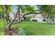 Beautiful single-story home featuring lush landscaping, mature trees, and an attached garage at 1482 Waterford Dr, Zionsville, IN 46077