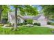 Charming single-story home with a manicured lawn, mature trees, and a welcoming front entrance at 1482 Waterford Dr, Zionsville, IN 46077