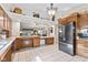 Open kitchen boasts stainless steel fridge, long counters, and decorative top shelving at 1482 Waterford Dr, Zionsville, IN 46077