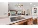 Open kitchen with island cooktop overlooking the living and dining areas at 1482 Waterford Dr, Zionsville, IN 46077