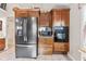 Kitchen with stainless steel appliances, wood cabinetry, and tile floor at 1482 Waterford Dr, Zionsville, IN 46077