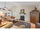 Comfortable living room with fireplace, wood floors and view into the kitchen at 1482 Waterford Dr, Zionsville, IN 46077