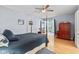 Inviting bedroom with hardwood floors, a four-poster bed, and access to a sunroom at 1482 Waterford Dr, Zionsville, IN 46077