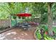 Landscaped patio with outdoor dining and swing set, perfect for relaxing and entertaining at 1482 Waterford Dr, Zionsville, IN 46077