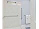 Handicap accessible shower with textured walls and chrome grab bars at 1482 Waterford Dr, Zionsville, IN 46077