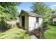 Exterior view of the storage shed featuring a single window, door opening and garden border at 1482 Waterford Dr, Zionsville, IN 46077