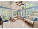 Bright sun room with vaulted ceiling, rattan furniture, and tiled floor at 1482 Waterford Dr, Zionsville, IN 46077