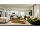 Open-concept living area with modern furniture, a view of the kitchen, and ample natural light at 15437 Manderley St, Fishers, IN 46040