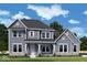 Charming two-story home featuring gray siding, a covered front porch, and beautifully landscaped surroundings at 15926 Bellows Ave, Fishers, IN 46040