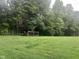 Expansive backyard with a wooded area and a rustic chicken coop, perfect for outdoor enjoyment and hobby farming at 162 W Robertson Rd, Morgantown, IN 46160