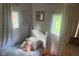 A bedroom with neutral walls and carpet, featuring decor, a bed with stuffed animals, and windows at 162 W Robertson Rd, Morgantown, IN 46160