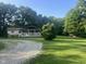 Charming home with a covered front porch, stone accents, and surrounded by lush greenery offering a serene setting at 162 W Robertson Rd, Morgantown, IN 46160