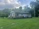 Ranch home featuring stone accents, a covered porch, and a large yard with mature trees, offering a peaceful retreat at 162 W Robertson Rd, Morgantown, IN 46160