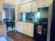 A view of the kitchen featuring black appliances, white cabinets, and hardwood flooring at 162 W Robertson Rd, Morgantown, IN 46160