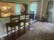 A view of a living room with a kitchen bar area featuring chairs, connected to the dining room at 162 W Robertson Rd, Morgantown, IN 46160