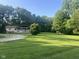 Peaceful home with a large yard, framed by tall trees creating a private, serene setting at 162 W Robertson Rd, Morgantown, IN 46160