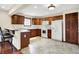 Functional kitchen featuring wood cabinets, white appliances, and a convenient breakfast bar for casual dining at 177 Jacinta Pl, Bargersville, IN 46106