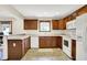 Traditional kitchen featuring wood cabinets, tile floors, white appliances, and recessed lighting at 177 Jacinta Pl, Bargersville, IN 46106