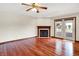 Bright living room showcasing hardwood floors, a classic fireplace, and French doors leading to the backyard at 177 Jacinta Pl, Bargersville, IN 46106