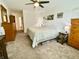 Spacious bedroom with a queen-size bed, carpet, and an armoire with ample storage at 213 Drewood Dr, Trafalgar, IN 46181