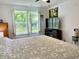 Spacious bedroom with a queen bed, a media center, and a bright window with shutters at 213 Drewood Dr, Trafalgar, IN 46181