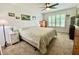 Bright bedroom featuring a comfortable queen-size bed and bright natural light streaming in from large window at 213 Drewood Dr, Trafalgar, IN 46181