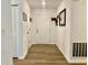 Bright entryway with hardwood flooring, white walls, and coat closet near the front door at 213 Drewood Dr, Trafalgar, IN 46181