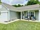 Charming home with inviting covered porch, well-manicured lawn, and tasteful landscaping at 213 Drewood Dr, Trafalgar, IN 46181