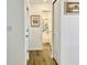Hallway featuring wood floors with open doorway into the bathroom and a closet and artwork at 213 Drewood Dr, Trafalgar, IN 46181
