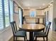 Open floor plan kitchen with stainless steel appliances, white cabinetry and a round wood dining table at 213 Drewood Dr, Trafalgar, IN 46181