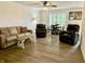 Open floor plan living room with hard wood floors and lots of natural light at 213 Drewood Dr, Trafalgar, IN 46181