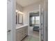 Bathroom featuring double vanity, walk-in shower, and view into a bright, well-decorated bedroom at 2169 Aviary Ln, Danville, IN 46122