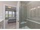 Bathroom featuring a glass shower and view into a bedroom with comfortable bed and plenty of natural light at 2169 Aviary Ln, Danville, IN 46122