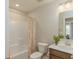 Bright bathroom with a white tub, an orange-patterned shower curtain, and a wood vanity with a faux plant at 2169 Aviary Ln, Danville, IN 46122