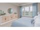 Bright bedroom featuring neutral walls, large window, and stylish wooden cabinet with decorative accents at 2169 Aviary Ln, Danville, IN 46122
